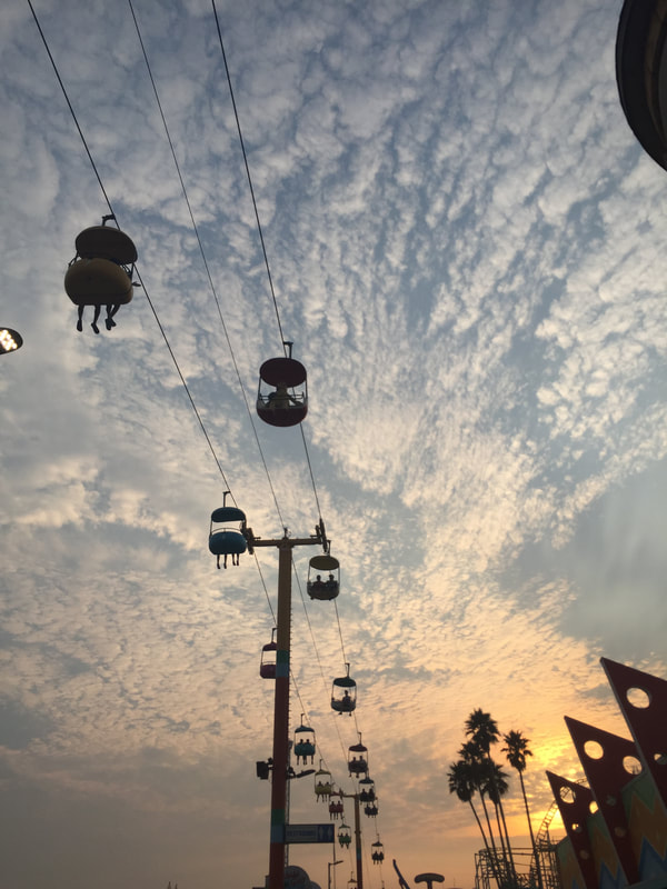 Boardwalk sky ride viewed from below against a cotton candy sky.